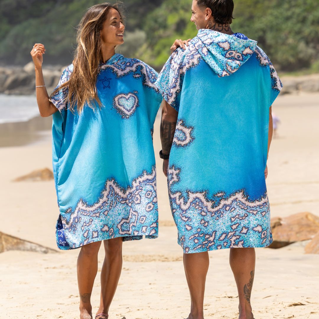 Front and back view of the Reef Love Changing Poncho Towel featuring a blue coral reef-inspired pattern, hooded design, and quick-dry fabric for comfortable beach changing and drying